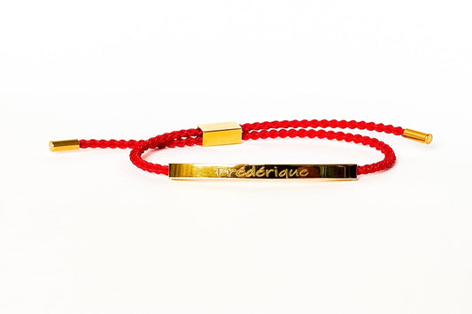 Red colored bracelet with a golden engravable bar