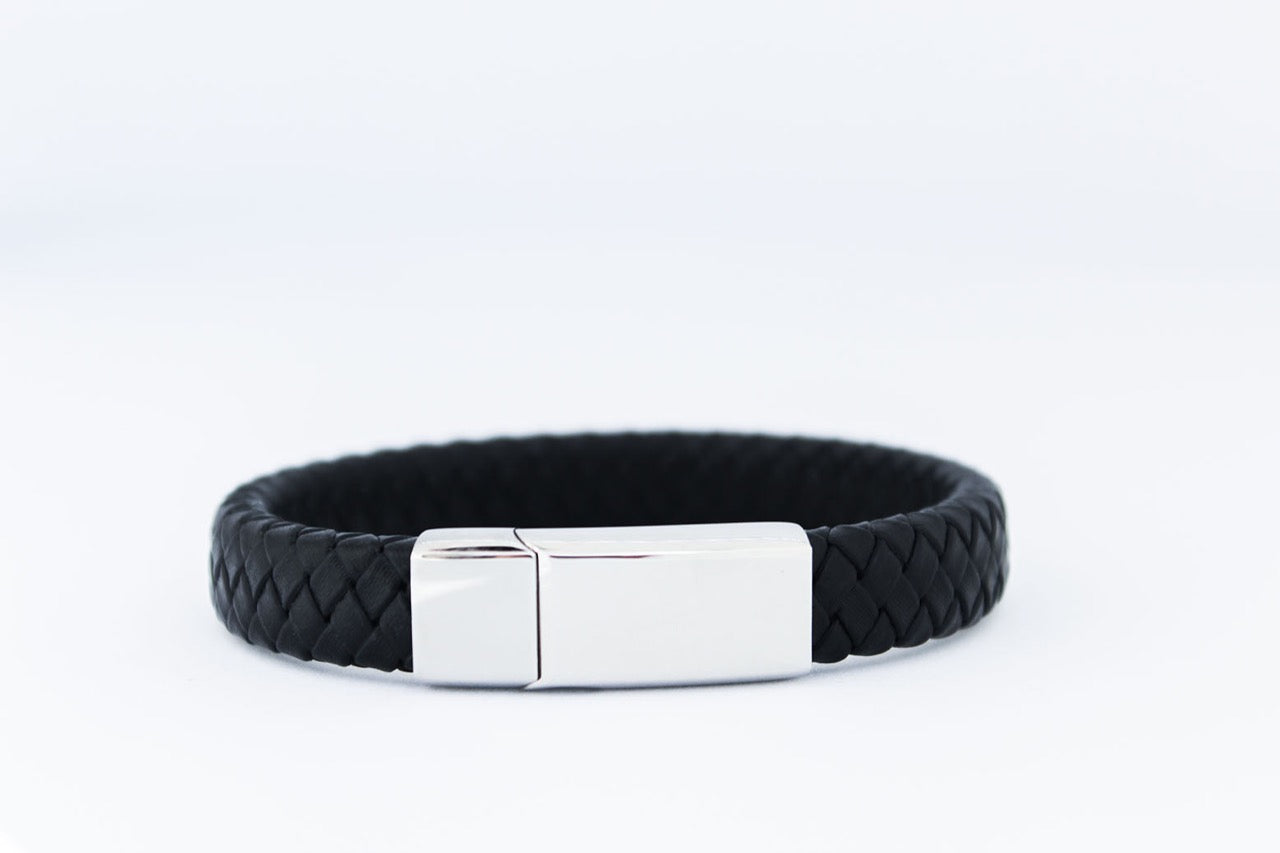 Zwart gevlochten leren Otis armband met zilverkleurige edelstalen sluiting, minimalistisch en stoer herinneringssieraad van Néhlia.